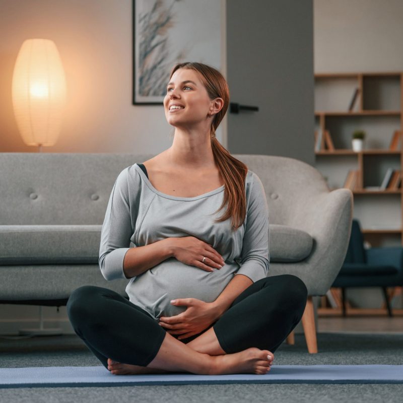 sitting-on-the-yoga-mat-beautiful-pregnant-woman-2022-11-04-03-29-22-utc-min